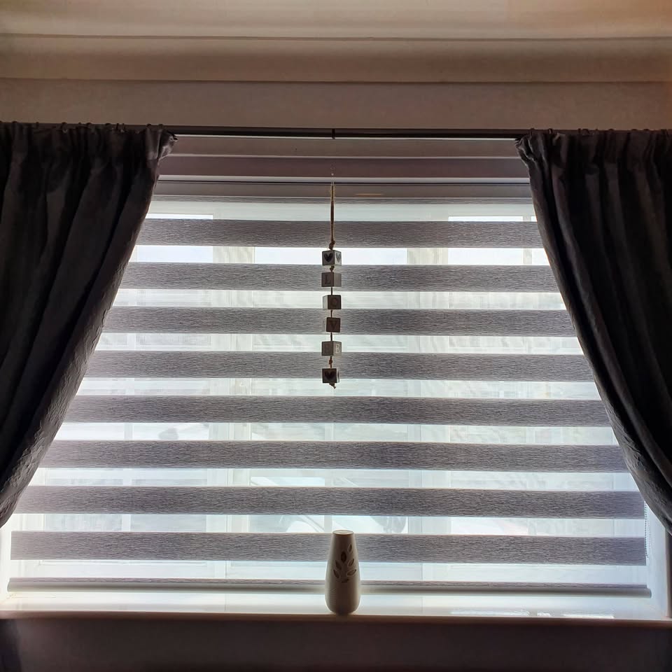 Grey day and night blind with alternating sheer and solid bands